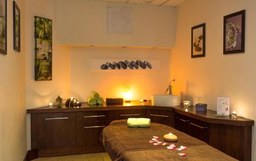 a room with a kitchen with a bed and a counter at Villa Cécile in Yvoire