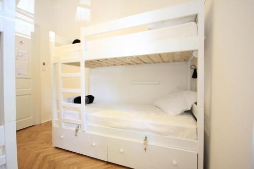 a white bunk bed with a ladder in a room at The Hostel in Zadar