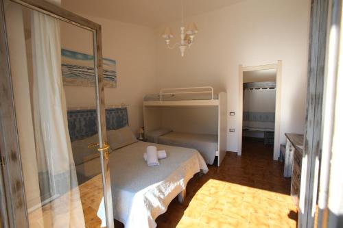 a small bedroom with a bunk bed and a mirror at Club Esse Sporting in Stintino