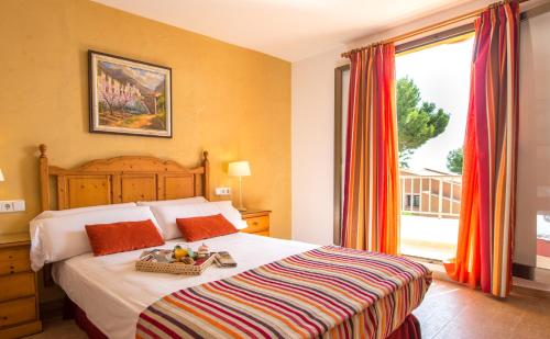 Postel nebo postele na pokoji v ubytování Aparthotel Ona Aucanada
