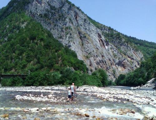 a man and a child standing in a river at NaBaDa in Tsʼageri