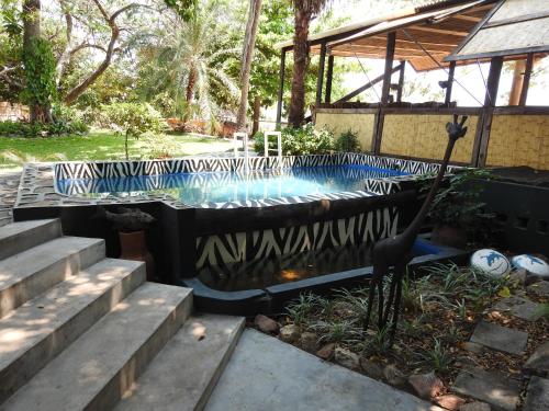 a swimming pool with a zebra pattern on it at Norman Carr Cottage in Monkey Bay