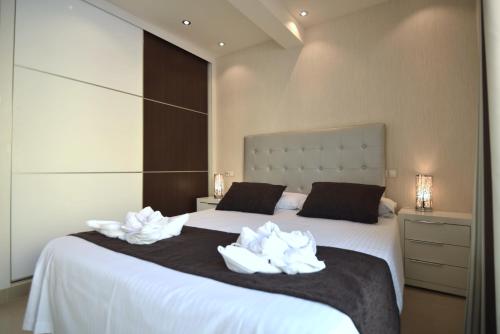 a bedroom with two beds with white towels on them at Apartamentos Fuerteventura Sol in Costa Calma