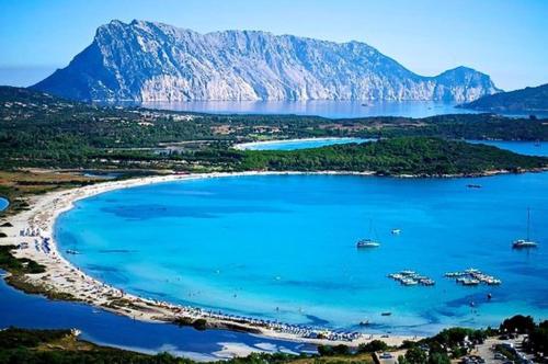 a view of a beach with boats in the water at B&B Tavolara in Puntaldia