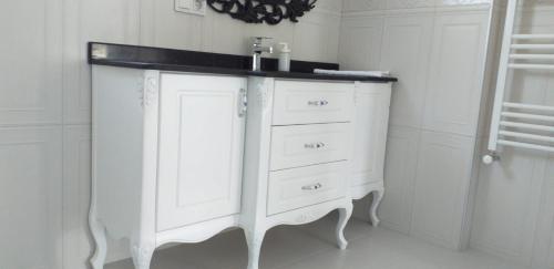 a white cabinet with a sink in a room at PALACE KIRKPINAR in Sakarya