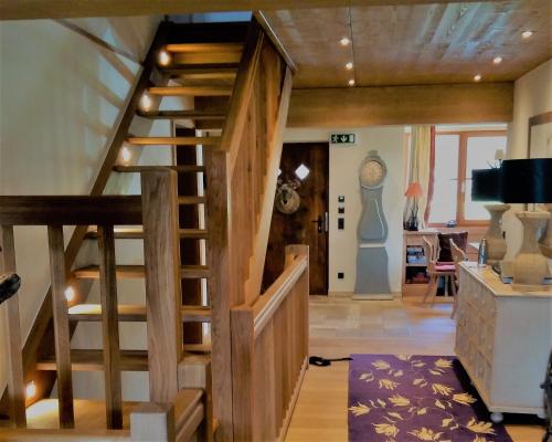 a hallway with a wooden spiral staircase in a house at Clubhotel Hinterthal Am Florysee 6 in Hinterthal