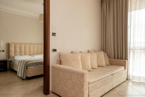 a living room with a couch and a bed at ApartHotel Anghel in Siena