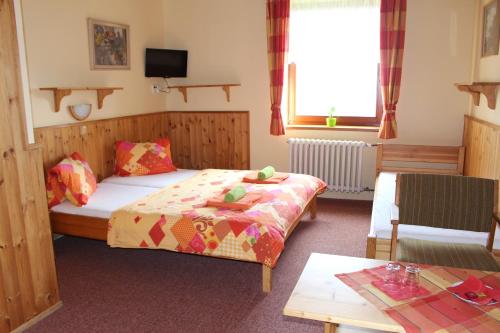 a small room with two beds and a table at Pension Horske Zatisi in Horni Misecky