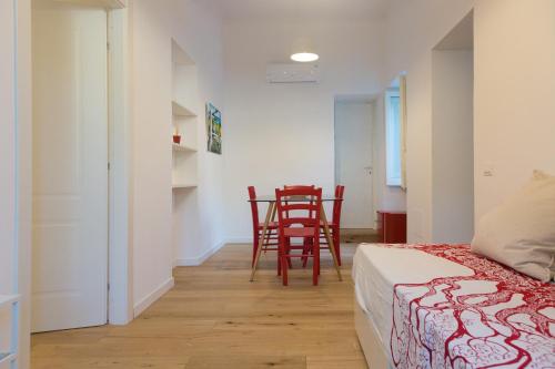 a bedroom with a bed and a table and chairs at Villa Mallandrino in Mondello