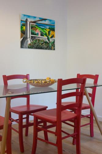 a table with four chairs and a plate of food on it at Villa Mallandrino in Mondello