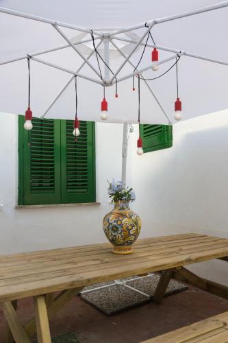 a vase sitting on top of a wooden table at Villa Mallandrino in Mondello