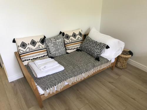 a couch with pillows on it in a room at Domaine de Selhac in Frontignan