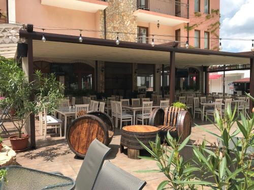 a patio with tables and chairs and tables and chairs at Oleander House and Tennis Club in Sunny Beach