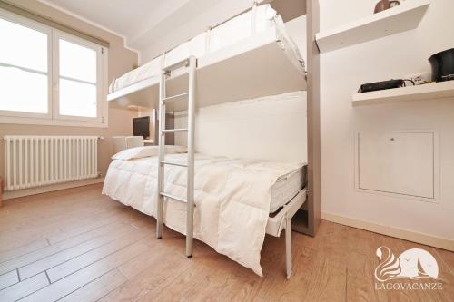 a bedroom with a bunk bed with a ladder at Studio Apartment Il Pelèr in Toscolano Maderno