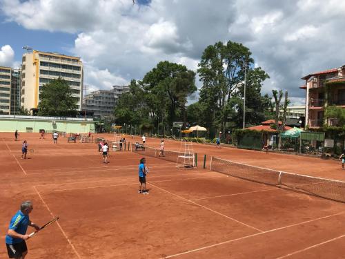 a group of people playing tennis on a tennis court at Oleander House and Tennis Club in Sunny Beach