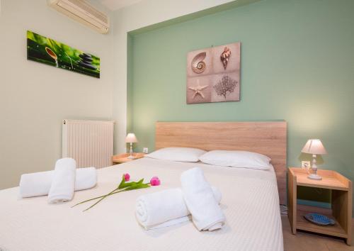 a bedroom with a large white bed with white pillows at Downtown Studio Chania in Chania