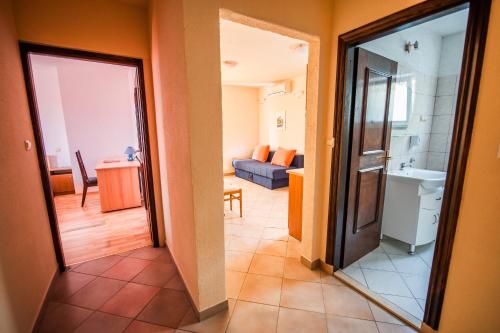 a view of a hallway with a bathroom and a living room at Apartments Alajbeg in Trogir