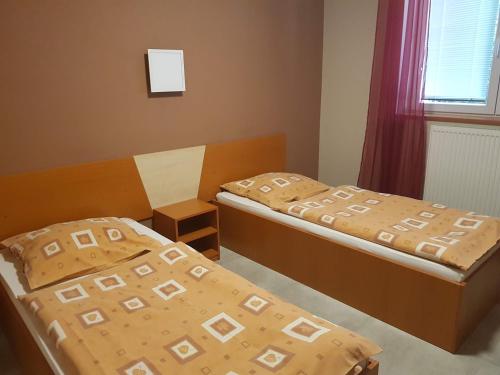 Кровать или кровати в номере Penzion Hudebka