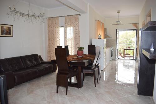 a living room with a table and a couch at Mary's apartments close to the sea in Agios Georgios