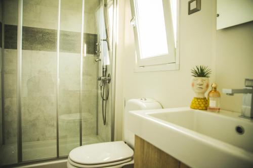 uma casa de banho com um WC, um lavatório e um chuveiro em Camping Vallecrosia em Vallecrosia