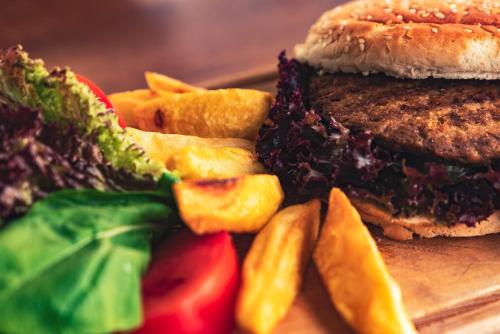 a sandwich and french fries on a plate at Hotel Karbel Sun in Oludeniz