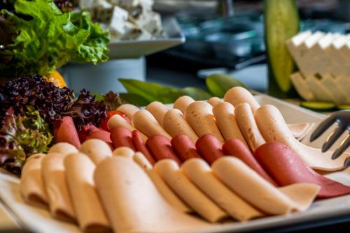 a plate of hot dogs and vegetables on a table at Hotel Karbel Sun in Oludeniz