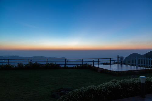 a view of the sunset from the deck of a house at The Xanadu, Coonoor in Coonoor