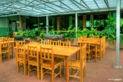 a group of wooden tables and chairs in a restaurant at La Selva Biological Station in Sarapiquí