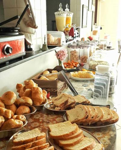 a buffet with many different types of bread and pastries at Pousada Maracabana Spa in Porto De Galinhas