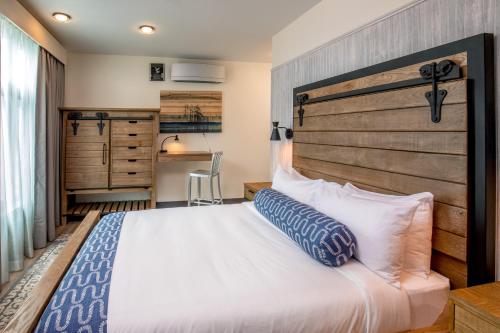 a bedroom with a large bed with a wooden headboard at Hotel 1868 in Cambridge
