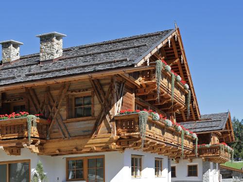 a large wooden house with two balconies on it at Chalet Piz da Peres in Valdaora