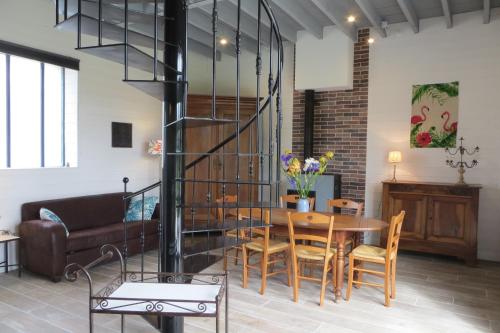 a living room with a table and a couch at LA GRANGE in Montlouis-sur-Loire