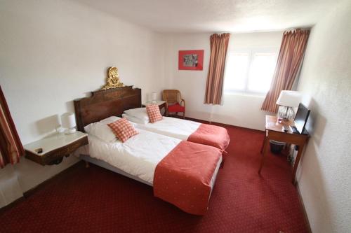 Postel nebo postele na pokoji v ubytování L'Auberge Catalane