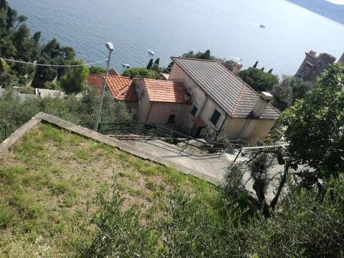 a house on the side of a hill near the water at Zoagli, the house of the sun in Zoagli