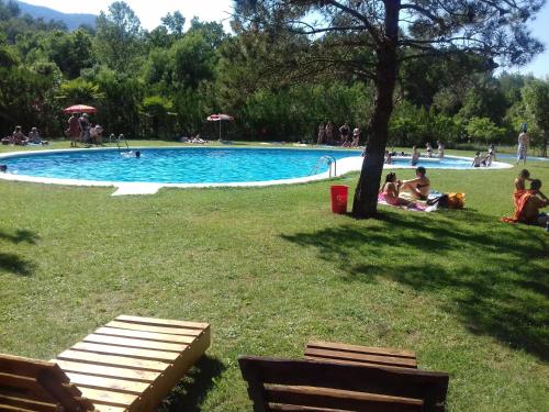 a group of people sitting around a swimming pool at Casa Julián Fábrica Giner in Morella