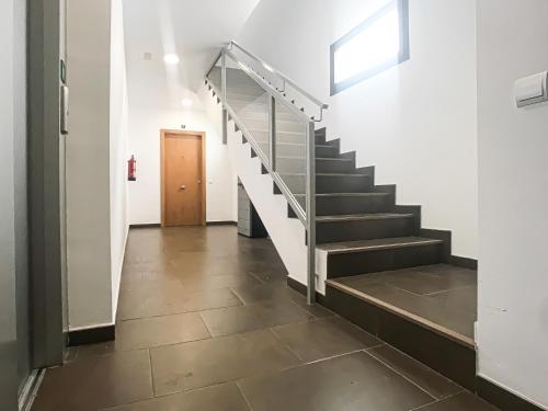 a hallway with stairs in a building with a door at Royal Suites Estepona by Croma in Estepona