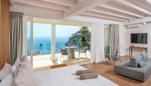 a bedroom with a bed and a view of the ocean at Iancu Charme Apartments in Taormina