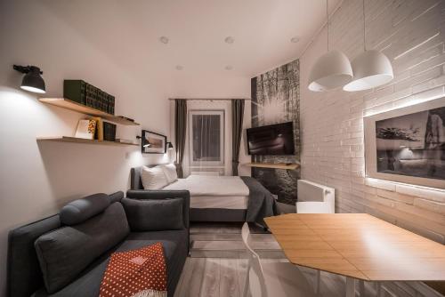 a living room with a couch and a bed at Revelton Studios Karlovy Vary in Karlovy Vary