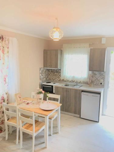 a kitchen with a table and chairs in a kitchen at Villa Bridge in Potamiá