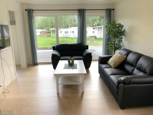 a living room with a couch and a coffee table at Saltvold Leilighet nr 2 in Røldal