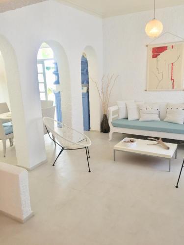 a living room with a couch and a table at Kyano House in Limenas