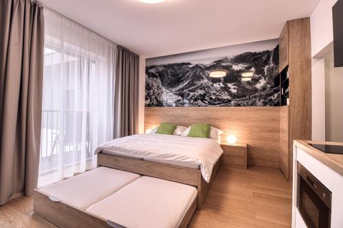 A bed or beds in a room at Trio Tatry