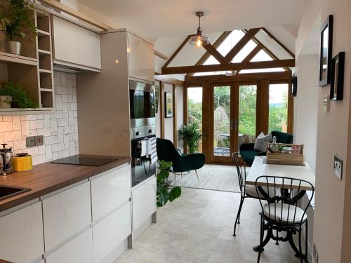a kitchen and dining room with a table and chairs at The Folly in Ludlow