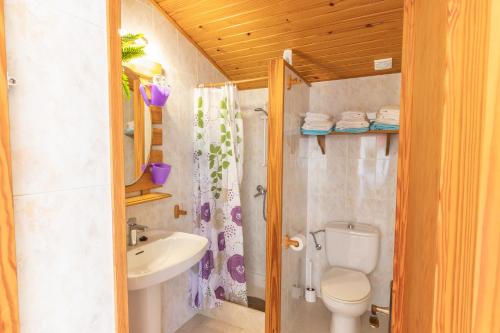 a bathroom with a toilet and a sink at Casa Aurora in Cala Santanyi