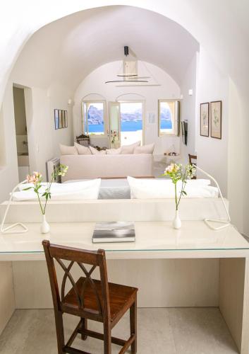 a bedroom with a large bed in a room at Aloia Villas in Oia