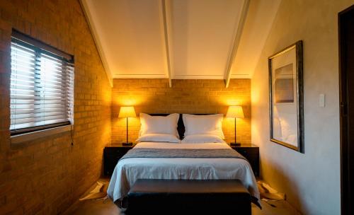 a bedroom with a large bed with two lamps at Twin Rivers Bed and Breakfast in Irene