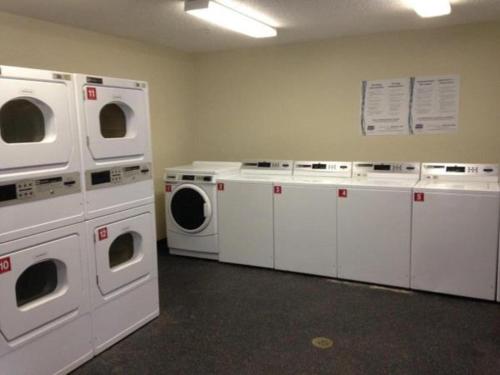 a laundry room with white washers and washing machines at InTown Suites Extended Stay Houston TX - West in Houston