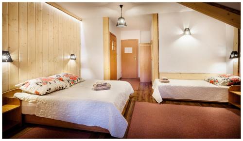 a hotel room with two beds at Tatrzańska Kotwica in Witów
