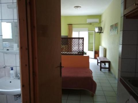 a room with a bathroom with a sink and a toilet at Angelica Apartments in Sidari