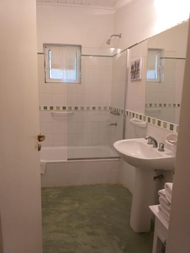 a white bathroom with a tub and a sink at Hotel Boutique Posada Piedras Blancas in Santa Rosa